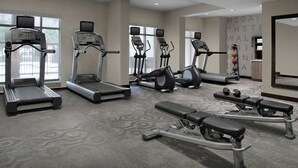 A gym with treadmills, elliptical machines, and weight benches. - Residence Inn by Marriott Jacksonville South/Bartram Park (Jacksonville)