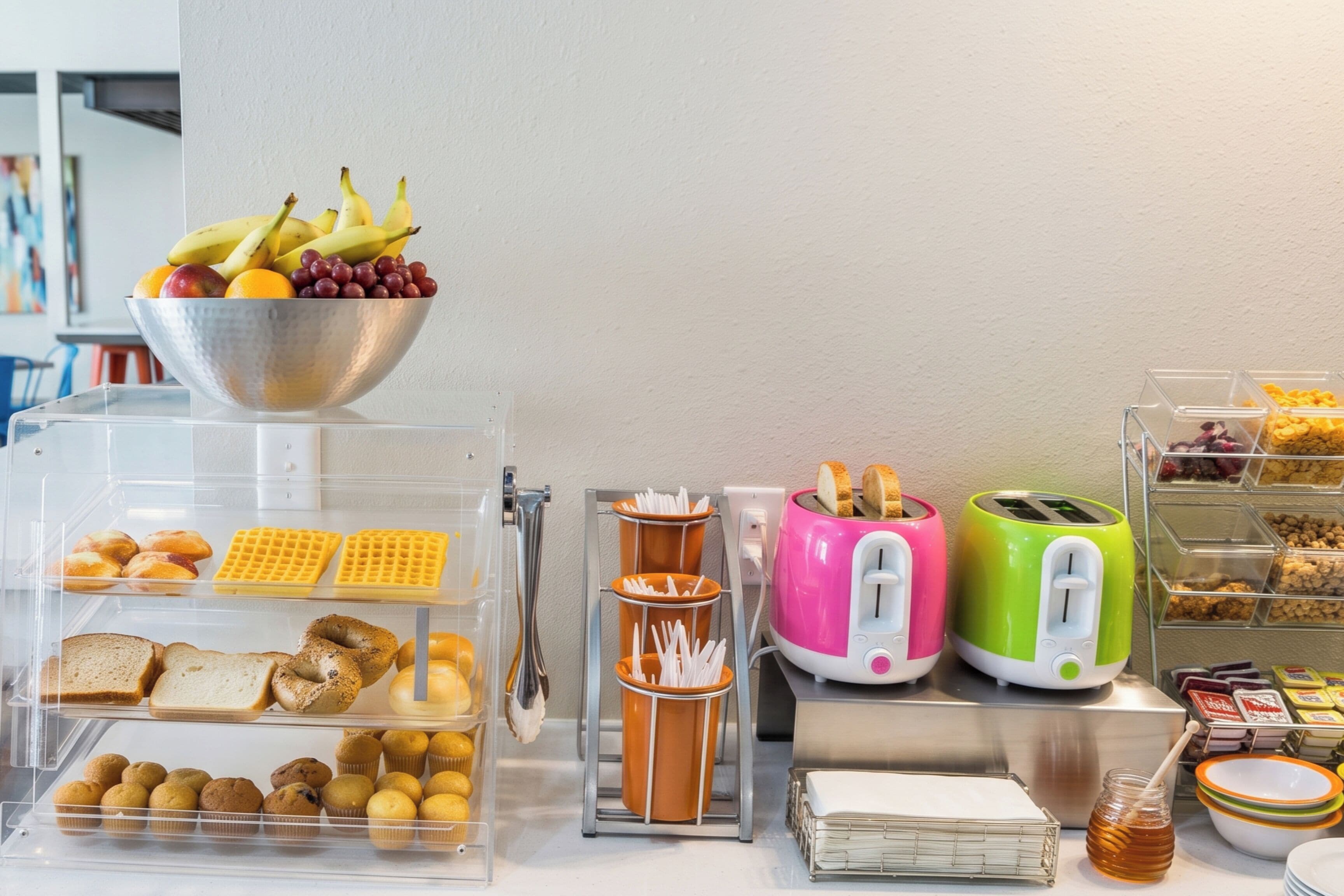 A breakfast buffet with various food items and appliances.