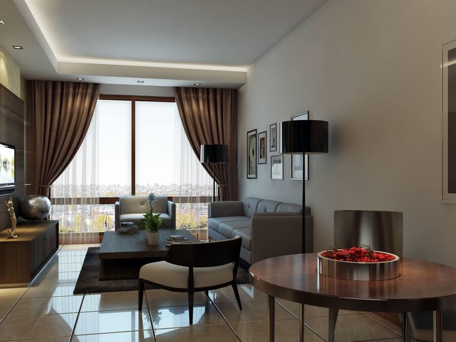 Una habitación de hotel moderna con un ventanal grande, un televisor de pantalla plana, un rincón de comedor con una mesa redonda y un sofá.
