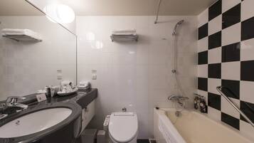 A modern bathroom with a black and white checkered wall, a large sink, a toilet, and a bathtub.
