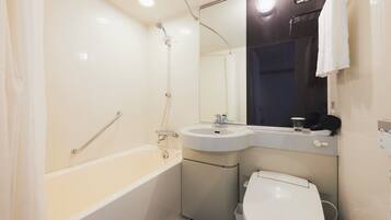 A modern bathroom with a bathtub, sink, and toilet.