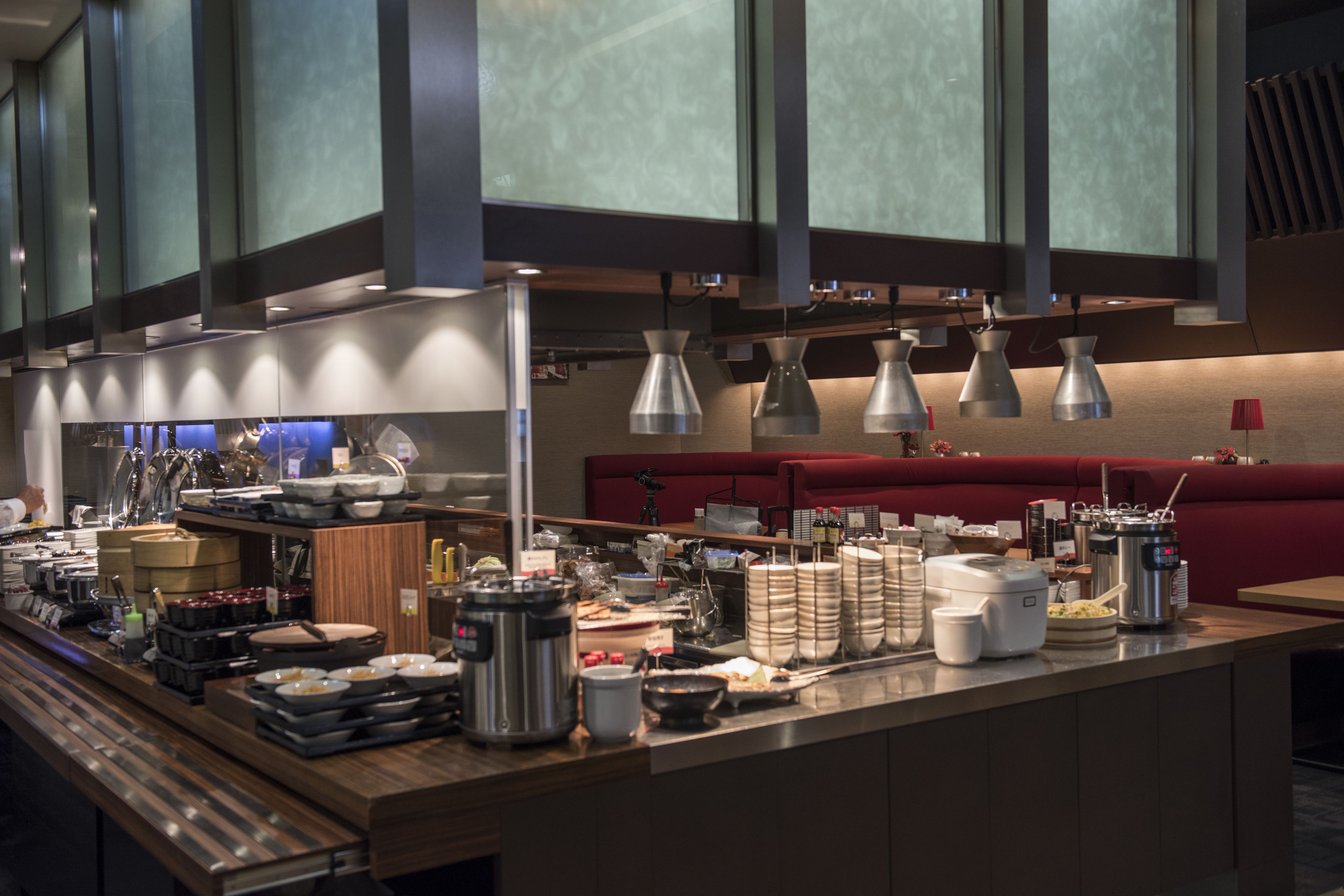 A well-equipped kitchen with stainless steel appliances, a variety of cookware, and overhead lighting.