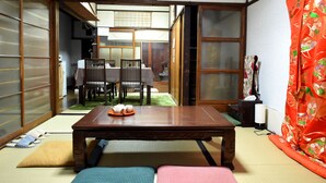 A traditional Japanese room with tatami flooring, a low wooden table with a tea set, and sliding shoji doors. - KYOMACHIYA NO YADO 794inn KIYOMIZUGOJO (Kyoto)