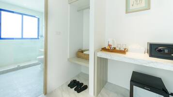 A modern bathroom with a shower, a toilet, and a sink area.
