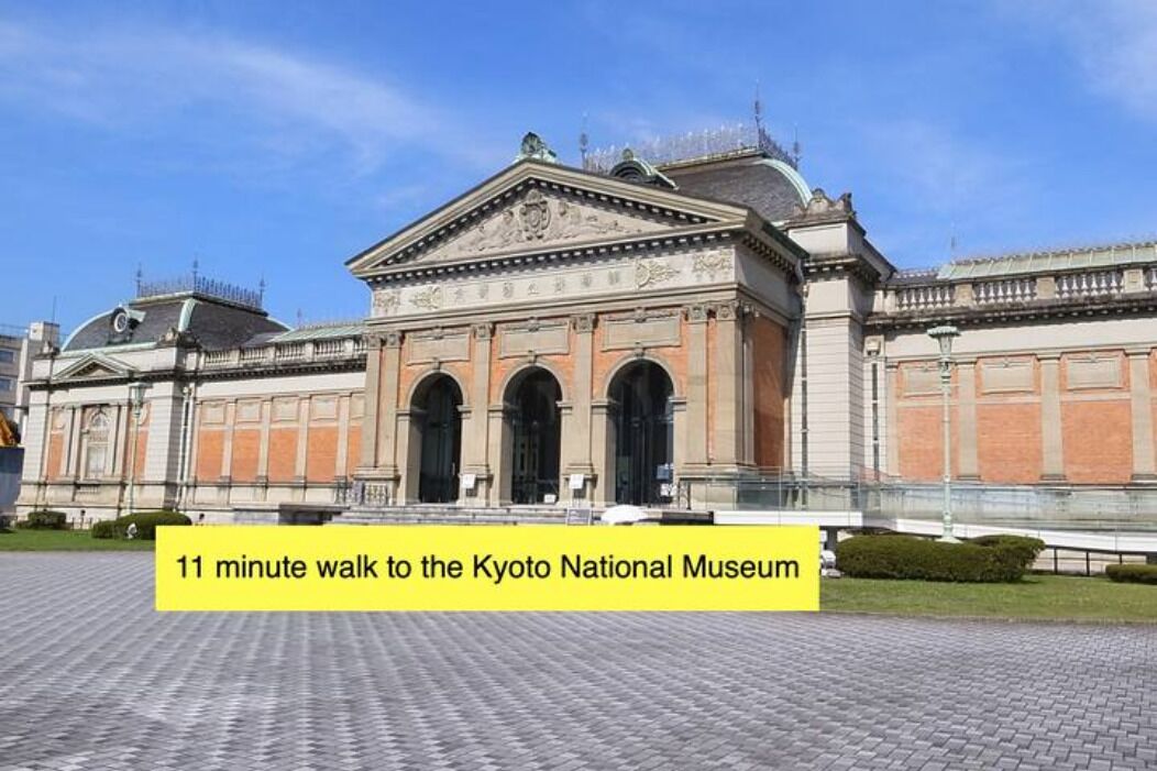 A historic building with classical architecture, likely a museum, with a paved courtyard in front.