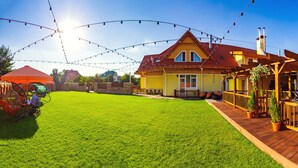 A house with a wooden deck, a covered patio, and a well-maintained lawn. - Kiev365 (Sofiivska Borschahivka)