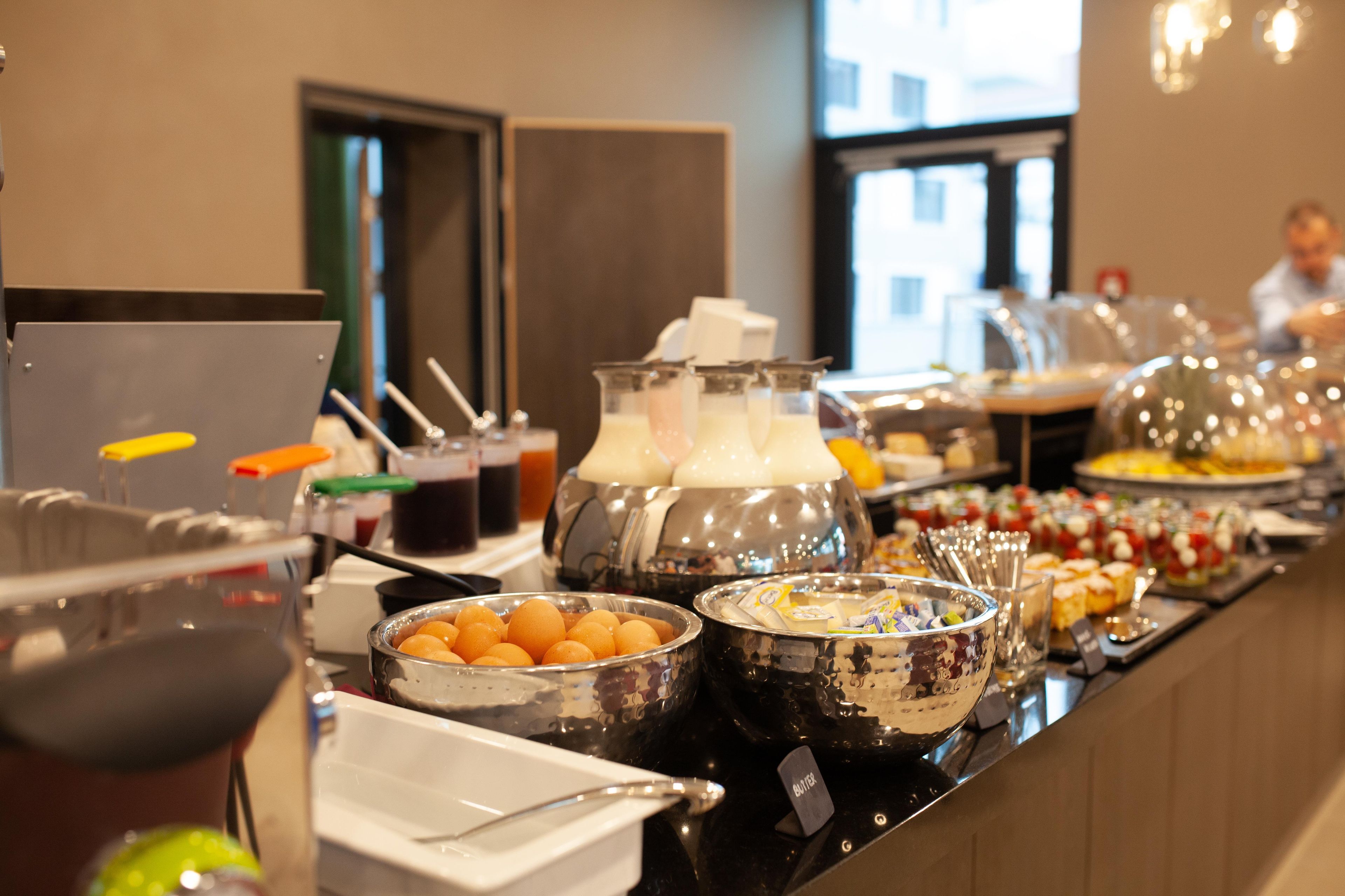 A buffet with various food items and condiments.