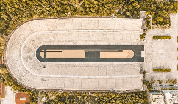 An aerial view of a large stadium with a central track and surrounding seating areas.