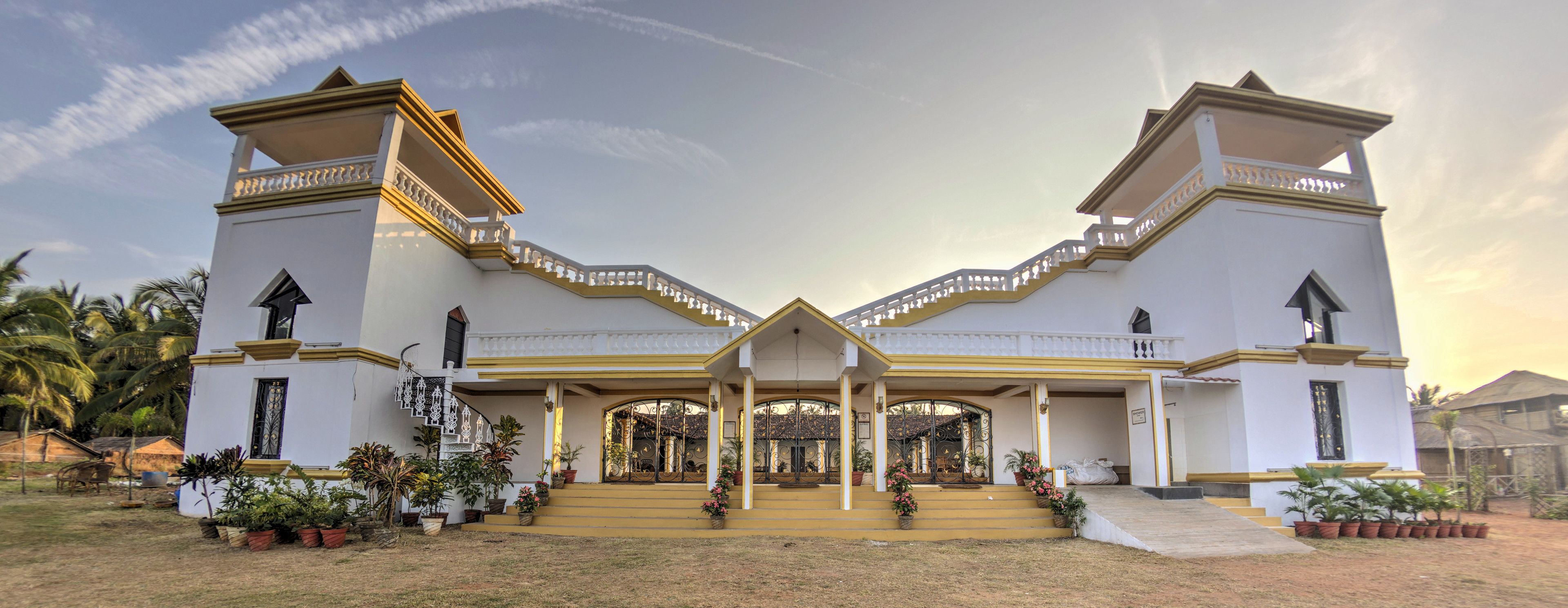 A large, symmetrical building with a central entrance and two towers on either side.