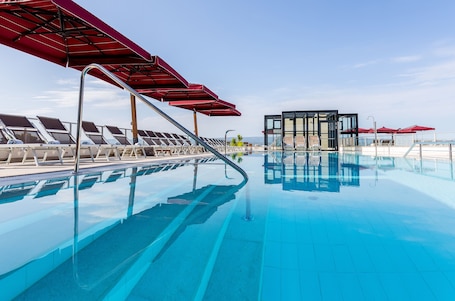 Indoor pool, seasonal outdoor pool, pool umbrellas, sun loungers