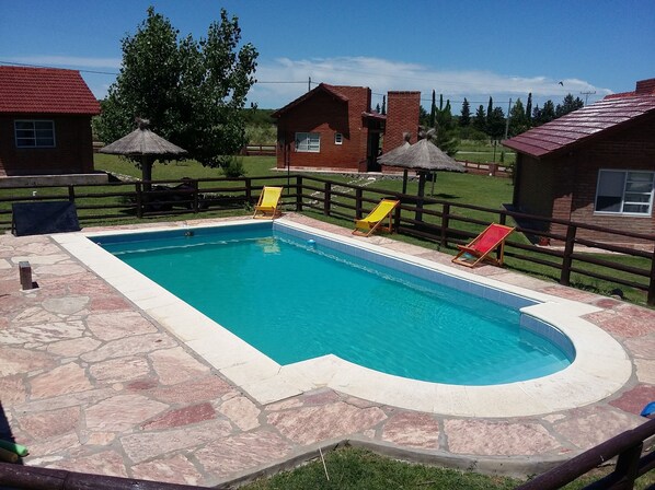 Seasonal outdoor pool, open 10:00 AM to 8:00 PM, pool umbrellas