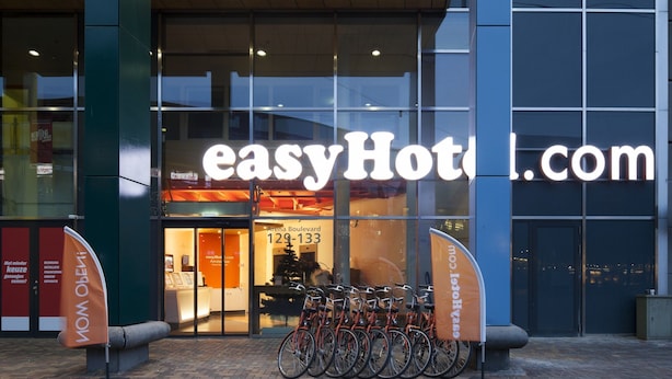 A modern building with a prominent sign reading "easyHotel.com".