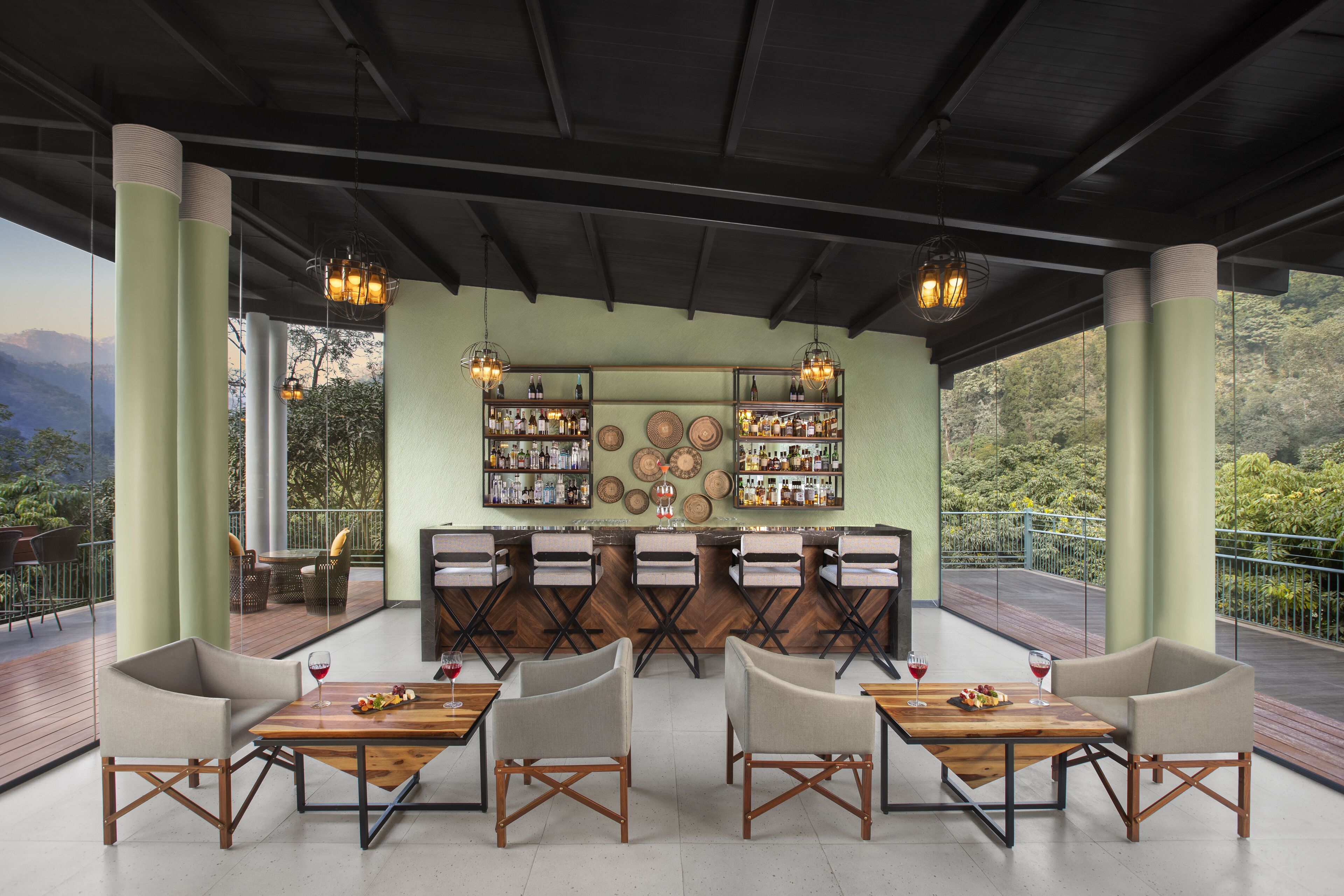 A bar area with multiple seating options and a view of the outdoors.
