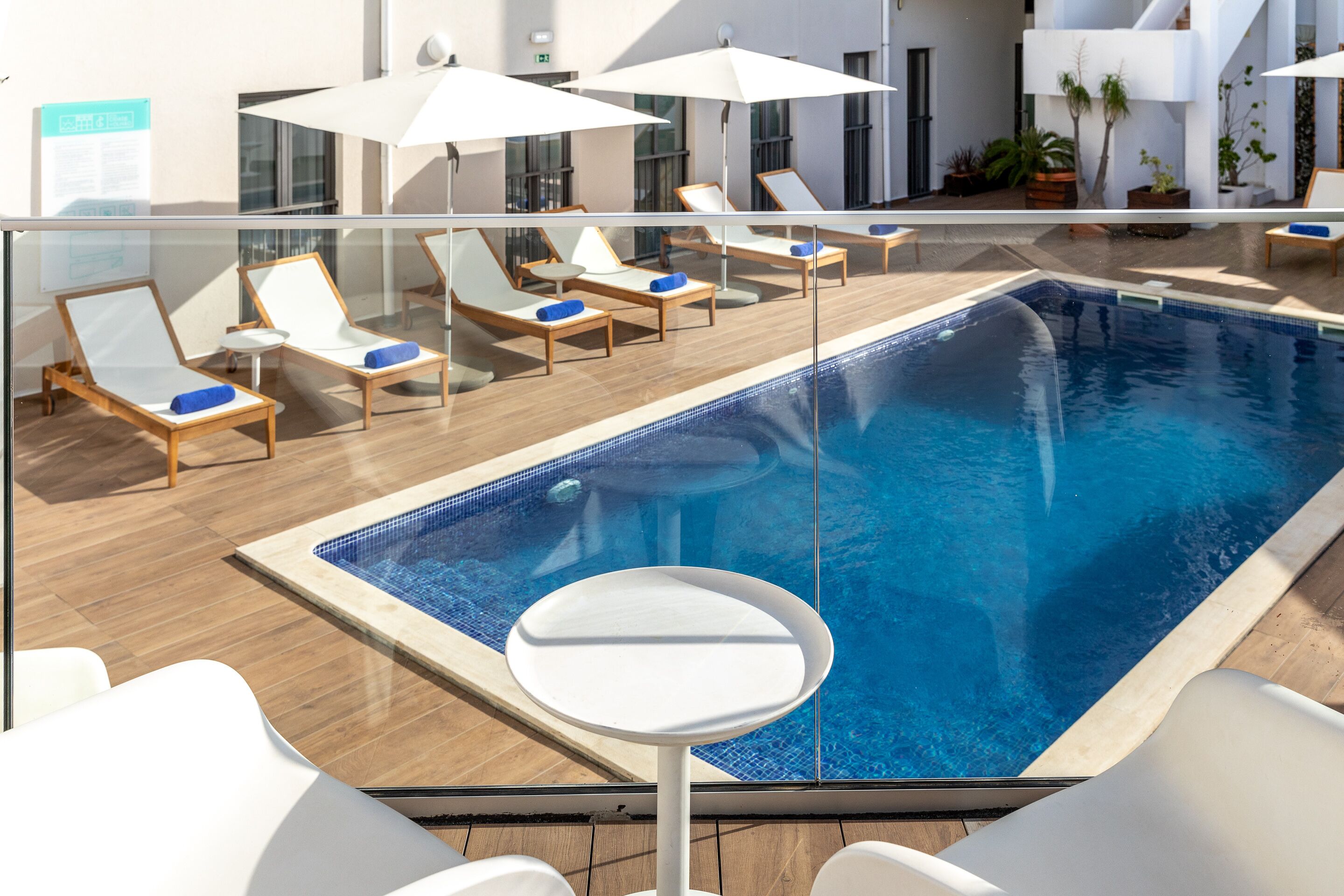 outdoor pool, pool umbrellas, pool loungers