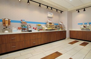 A self-service breakfast area with various food options, including cereal, hot water, and fruit. - Holiday Inn Express & Suites Brookshire - Katy Freeway by IHG (Brookshire)