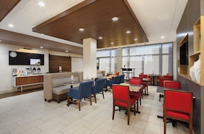 A modern hotel lobby with a reception desk, seating area, and large windows. - Holiday Inn Express & Suites Brookshire - Katy Freeway by IHG (Brookshire)