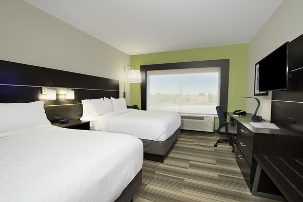 A hotel room with two beds, a desk, a chair, a TV, and a large window with a city view. - Holiday Inn Express & Suites Brookshire - Katy Freeway by IHG (Brookshire)