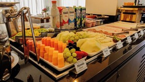 A buffet with various food items including fruits, cheeses, and beverages. - Marsala Apart Hotel (Mogi das Cruzes)