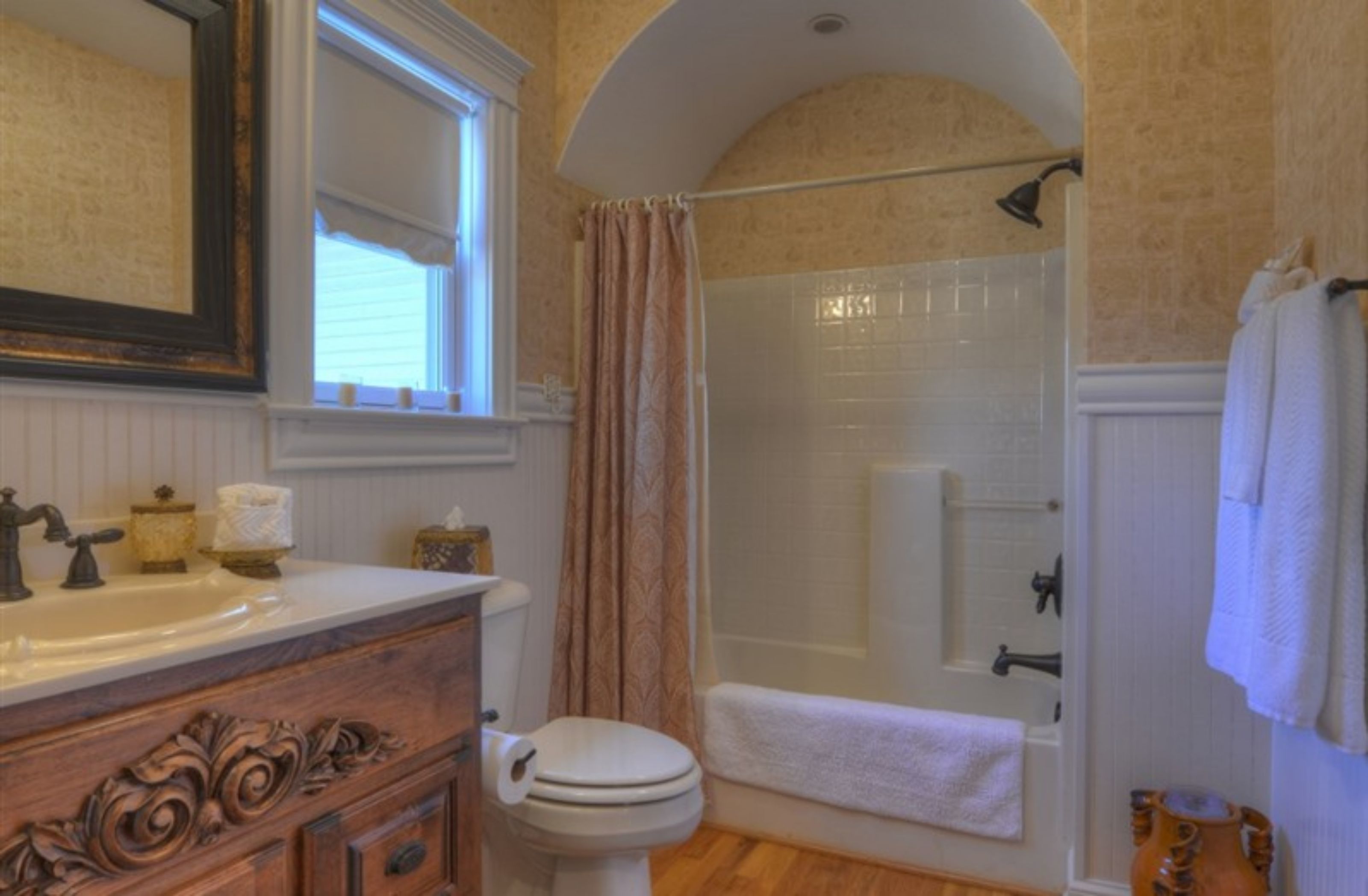A bathroom with a sink, toilet, and shower.