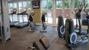 A gym with treadmills, stationary bikes, and weight machines. - Miami Luxury Suite in Downtown Brickell (Miami)