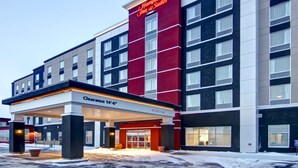 A Hampton Inn & Suites hotel with a clear entrance, a 14'-6" clearance sign, and a modern facade.