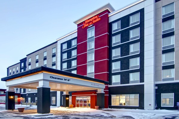 A Hampton Inn & Suites hotel with a clear entrance, a 14'-6" clearance sign, and a modern facade. - Hampton Inn & Suites by Hilton Grande Prairie (Grande Prairie)