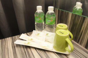 A tray with dental hygiene products, including toothbrushes and toothpaste, on a wooden surface. - Eco Garden Hotel (Serendah)