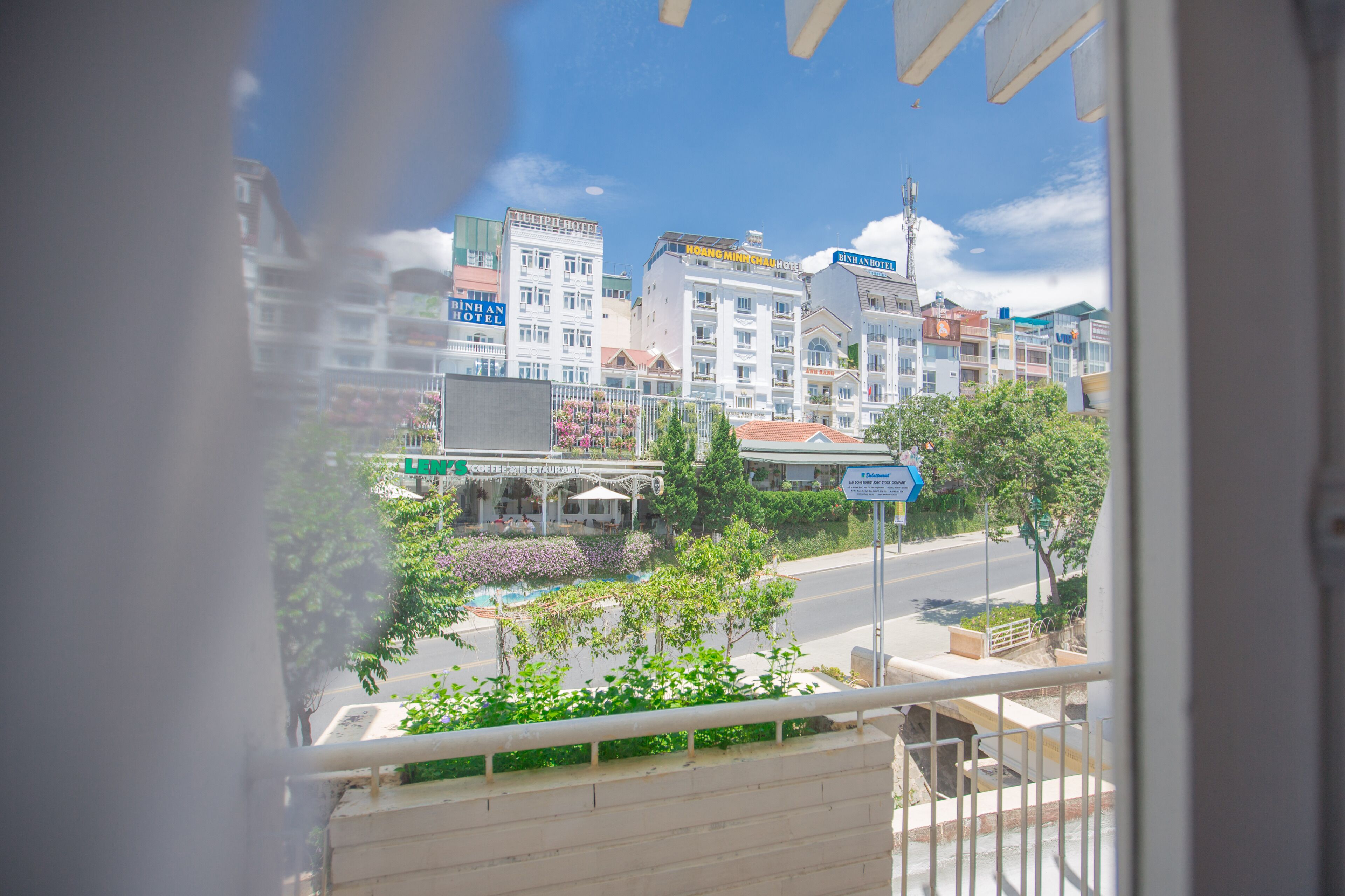 A view of a cityscape with multiple buildings, including hotels and a coffee restaurant.