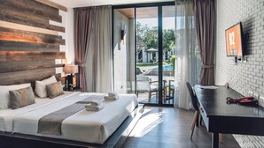 A hotel room with a bed, a desk, a TV, and a view of the outdoors. - B2 Pai Premier Resort (Pai)
