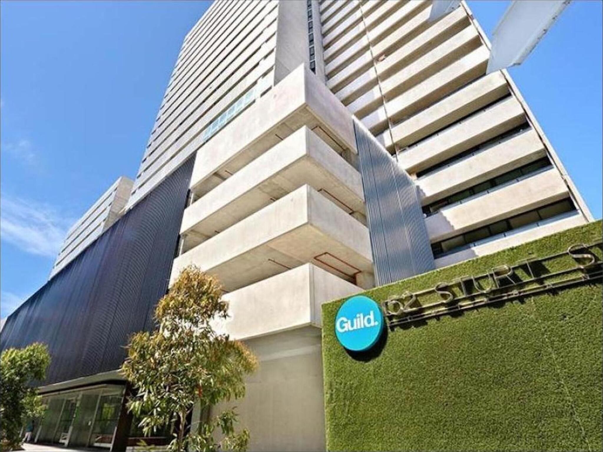 A modern building with a sign that reads "Guild."