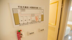 A hotel room layout with a fire escape route, emergency contact numbers, and a fire alarm key. - Chantai Hotel (Hualien City)