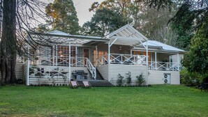 A two-story house with a balcony and a covered porch. - Moulton Park Homestead (Sassafras)