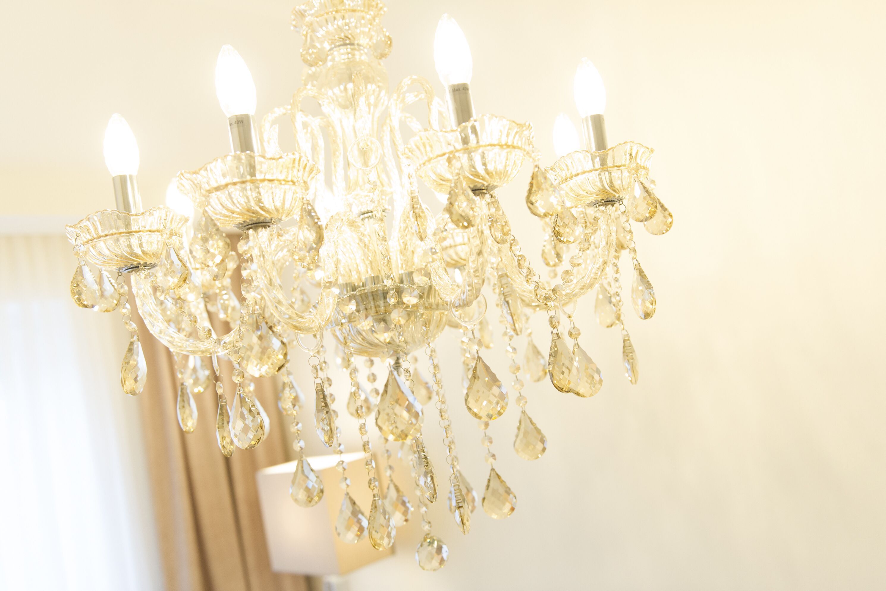 A chandelier with multiple arms and crystal decorations.