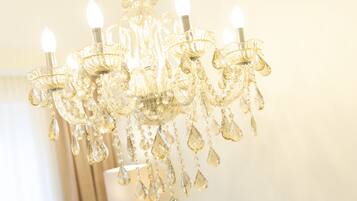 A chandelier with multiple arms and crystal decorations.