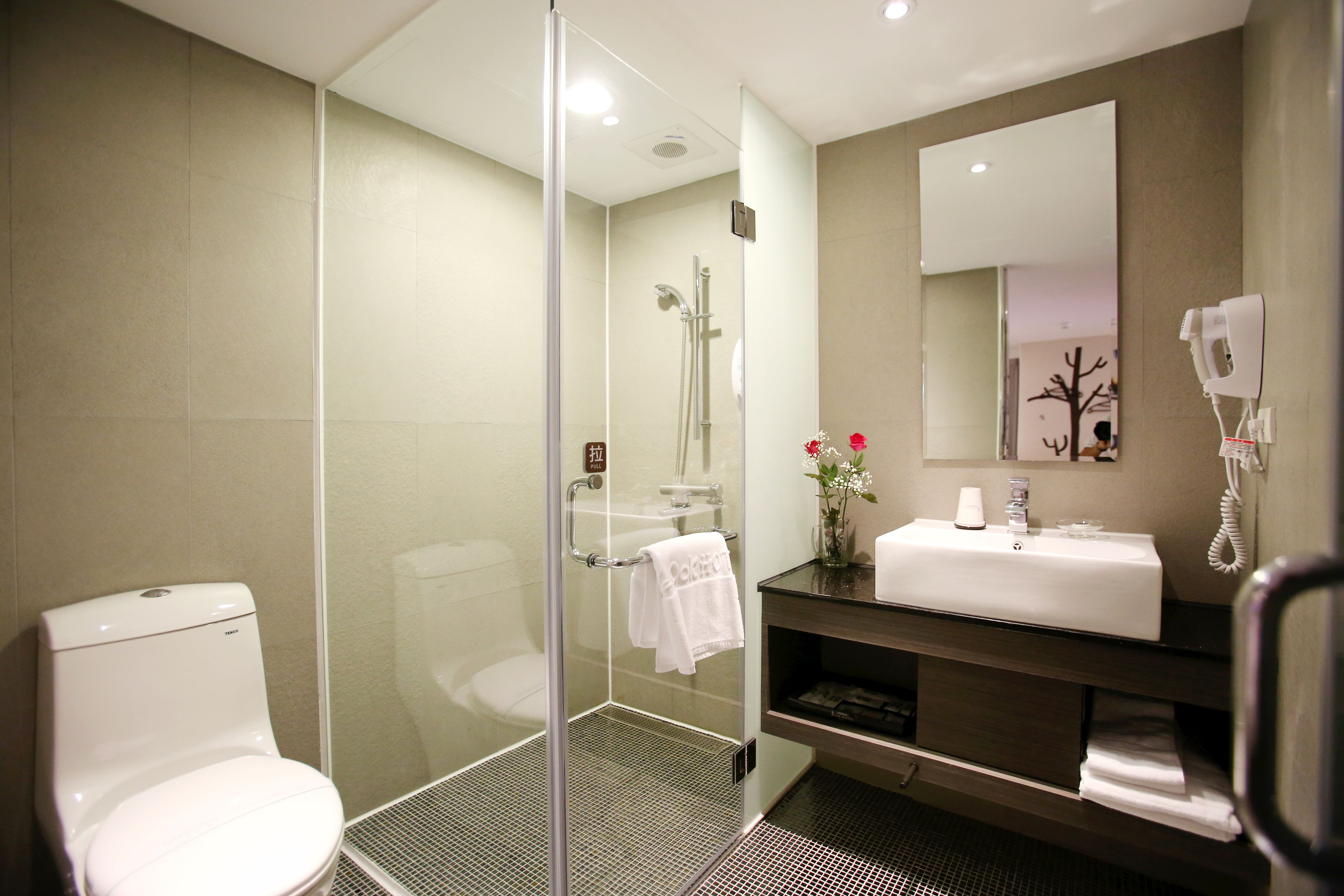 shower, hair dryer, slippers, towels