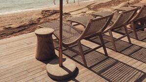 Privat strand, solsenger, parasoller og strandbar