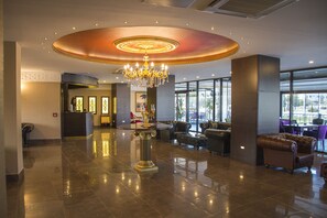 A lobby with a chandelier, seating area, and a reception desk. - Birizgarden Hotel (Elazig)