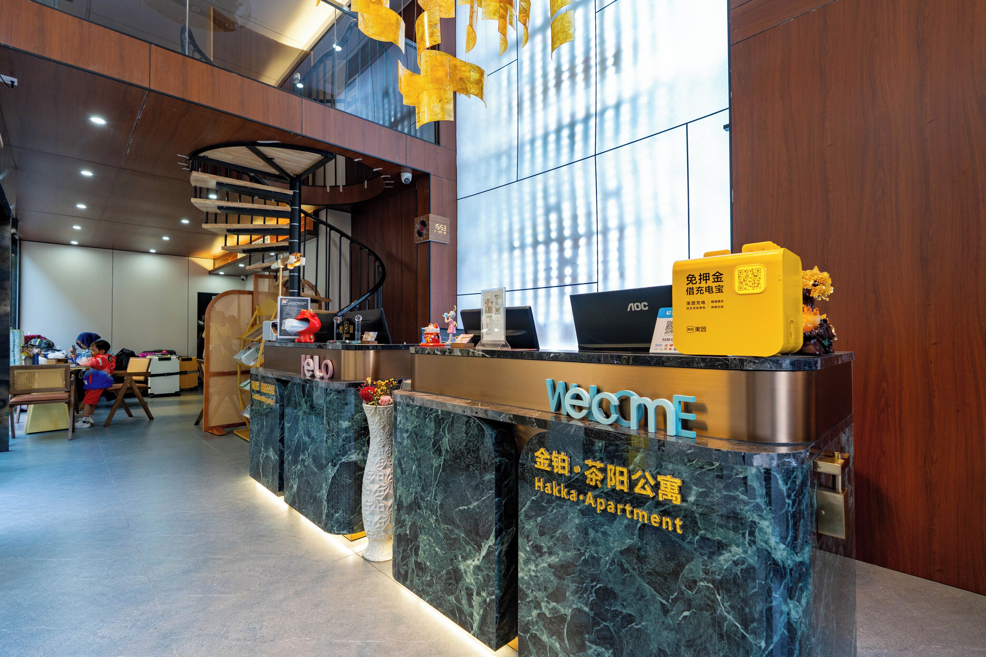 A reception desk with a marble top and a sign reading "Welcome".