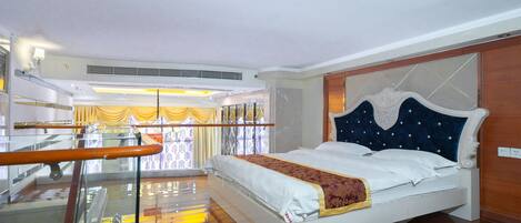 A hotel room with a bed, a balcony, and a view of the sea.