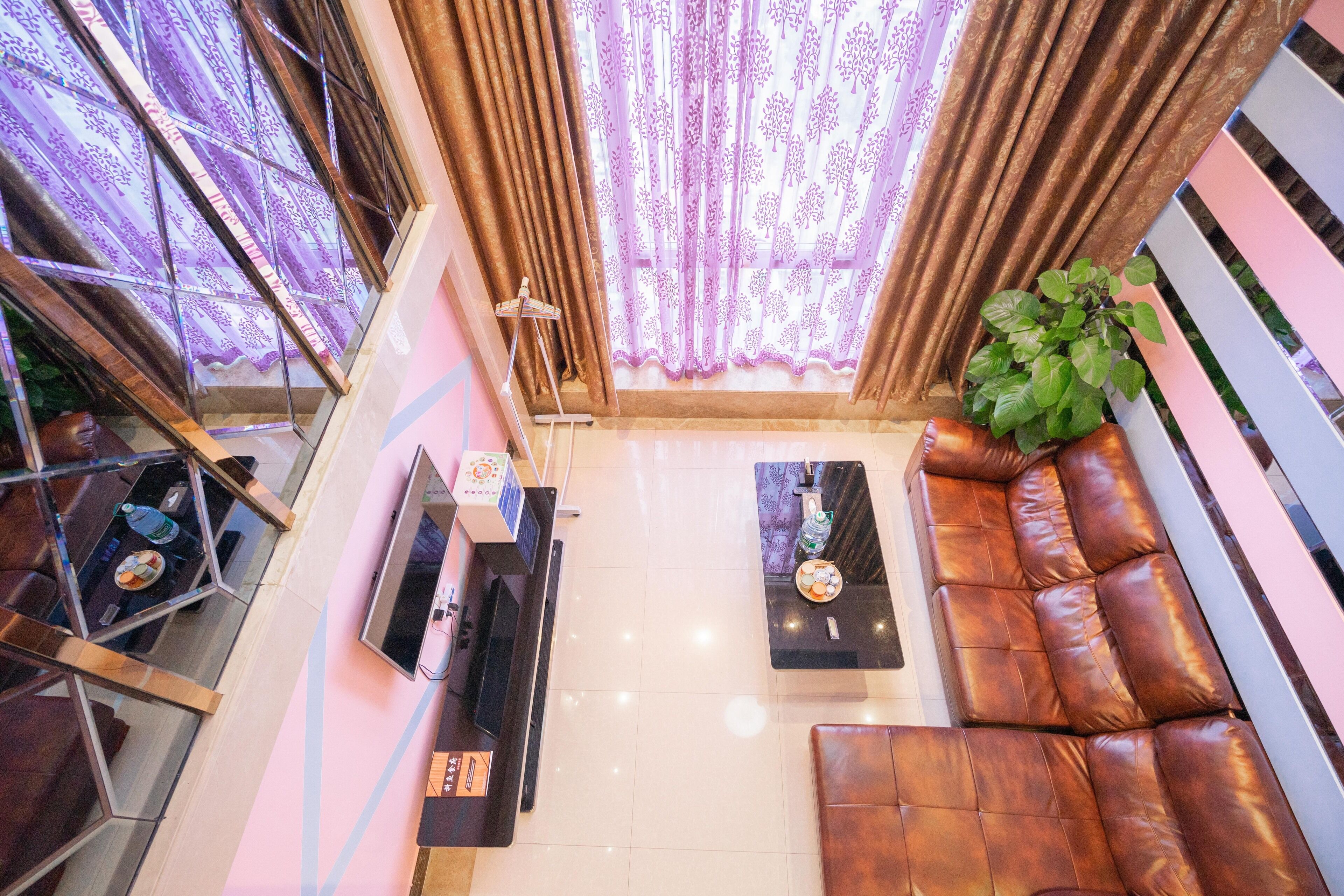 A modern living room with a sofa, a coffee table, and a TV.