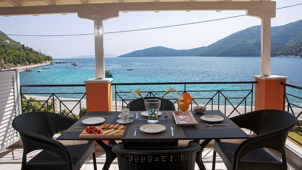 A table set for two with a view of the sea and mountains. - Captain Nick (Lefkada)