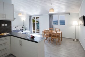 Apartment, Sea View | Living area | 32-inch LED TV with digital channels