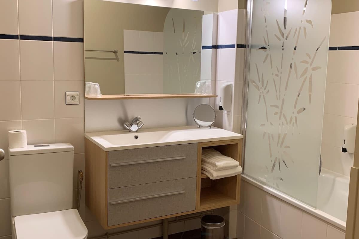 premium double room | bathroom | bathtub, deep-soaking bathtub, free toiletries, hair dryer