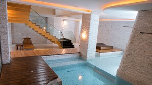 A modern indoor pool area with a wooden deck, a staircase, and a seating area. - All-Ur Boutique Motel - Tai-Chung Branch (Taichung)