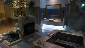 A modern bathroom with a glass-enclosed fireplace, a freestanding bathtub, and a large mirror above the sink. - All-Ur Boutique Motel - Chang-Hua Branch (Changhua)