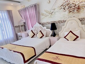 Deluxe Triple Room | Minibar, in-room safe, desk, blackout curtains - Godiva Phu Quoc Hotel (Phu Quoc)
