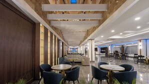 A modern hotel lobby with a long corridor, seating areas, and a reception desk. - Armas Gul Beach - All Inclusive (Kemer)