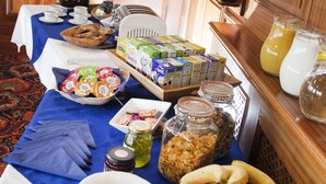 A breakfast buffet with various food items and beverages. - Somerfield Lodge (Swansea)