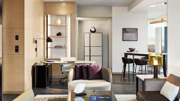 A modern living room with a sofa, coffee table, and dining area.