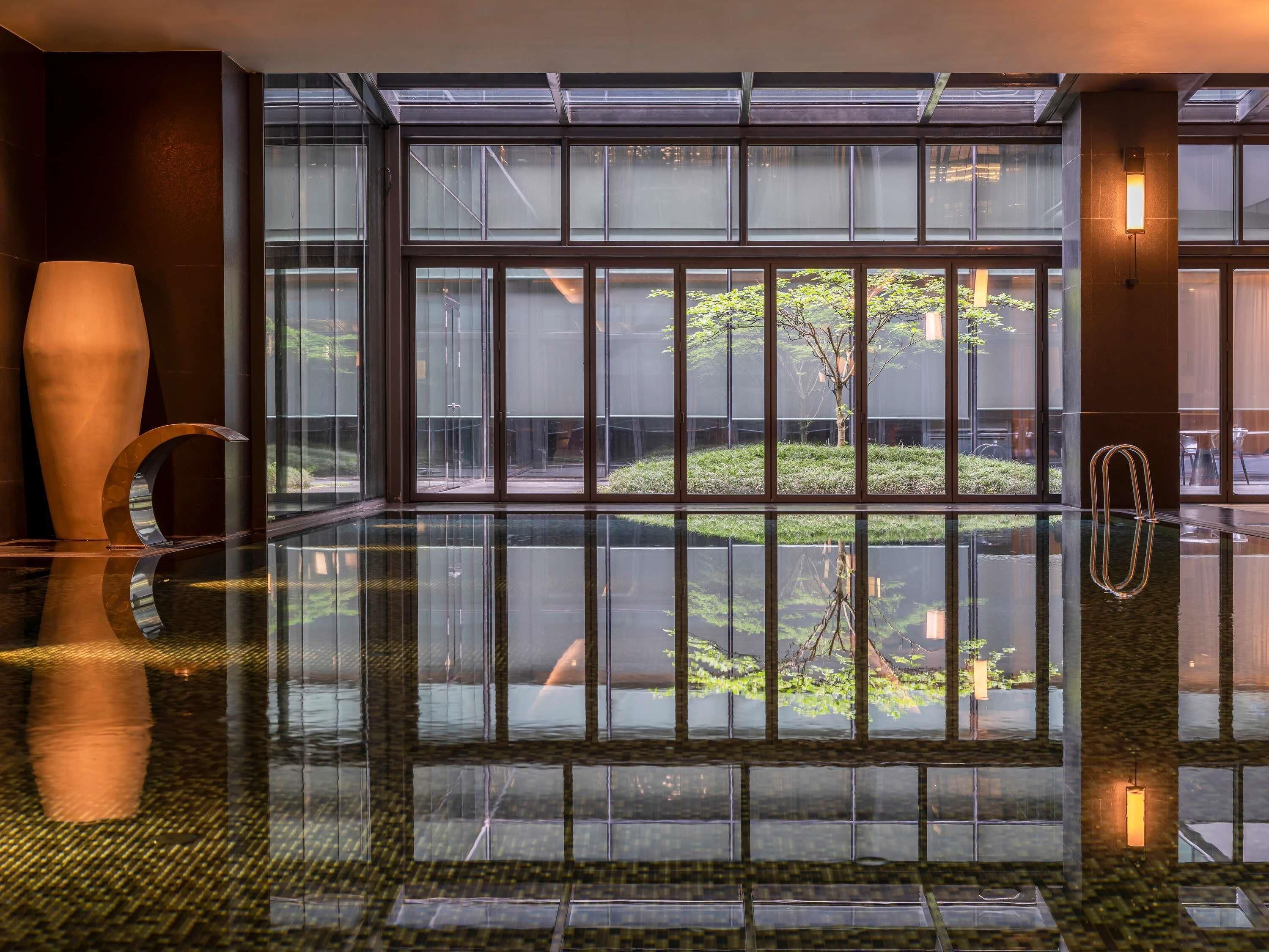 A modern lobby with a glass floor, large windows, and minimalist decor.